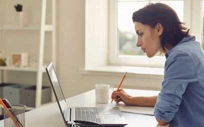 Woman Listening to Somebody during Online Lesson or Conference