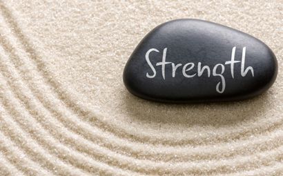 A stone with the word strength on it